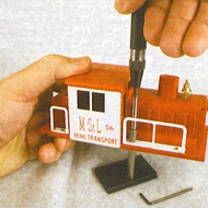 Tightening handrails on a motorized unit using the Original Riveter with tip BRT2-1 and BR1-P1 Backing Stake. Note the BREXT-1,1“ extension for the Original Riveter, which allows the body of the Original Riveter to stay safely away from the engine cab.